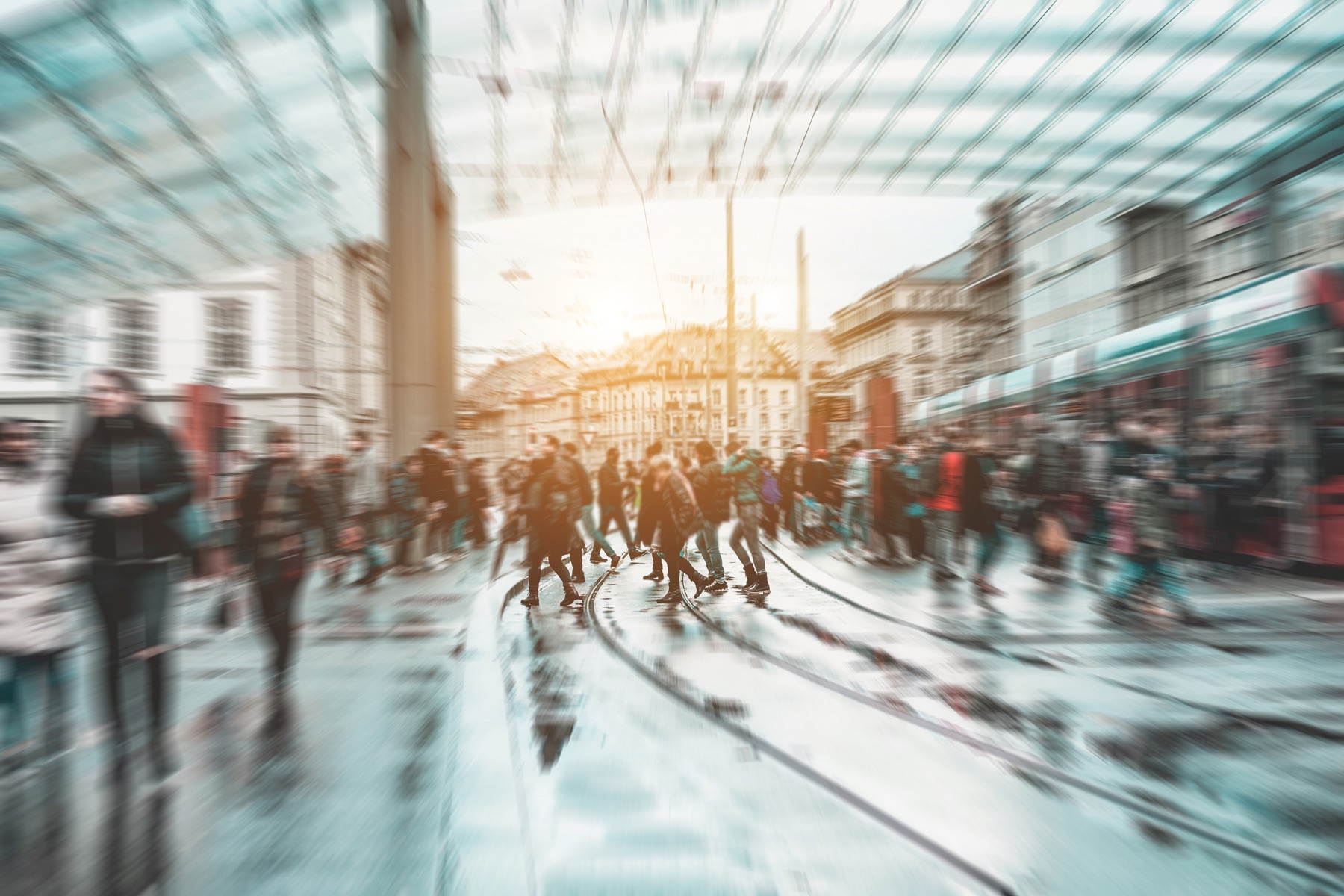 People moving through a sunlit city street